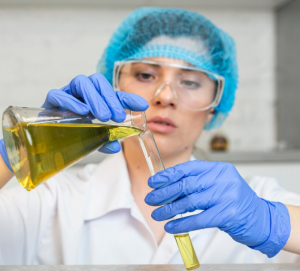 A woman filling chemicals in a cylinder tube